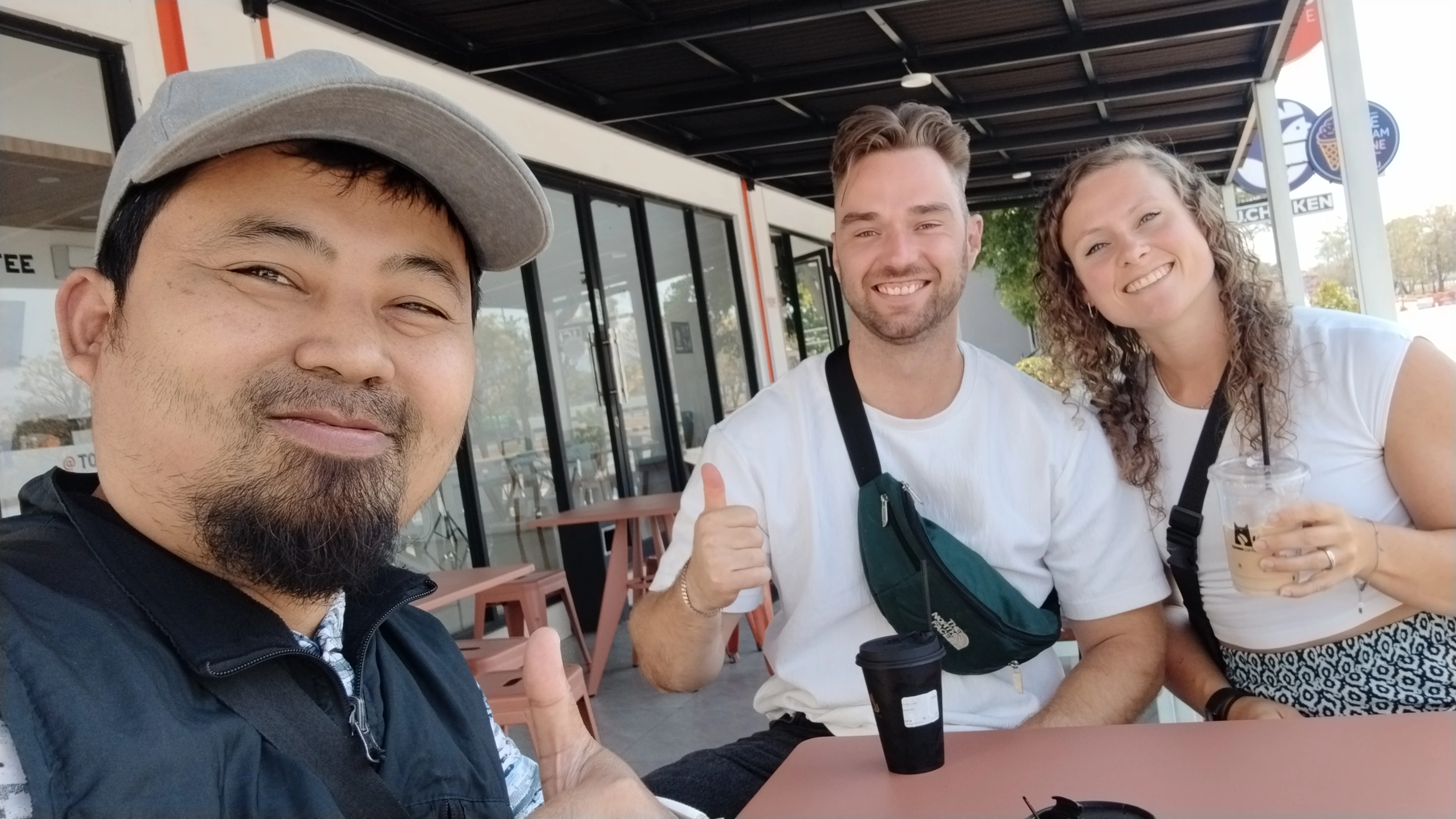 Dutch travelers and Zoy Travel driver having coffee at a rest area during a Pronojiwo to Surabaya Airport private transfer